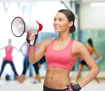 smiling fit woman with megaphone