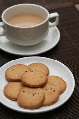 A cup of tea with biscuits