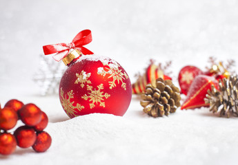 Fototapeta na wymiar Christmas ball with red bow and ribbon