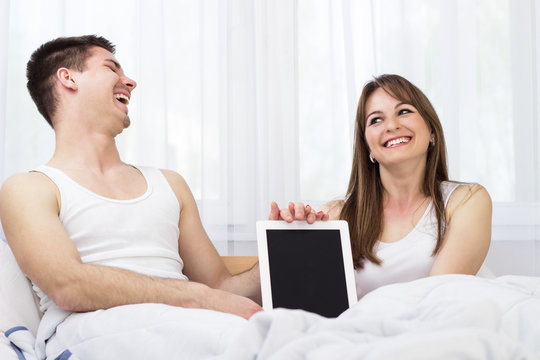 Happy young couple with digital tablet PC