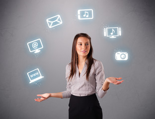 pretty girl juggling with elecrtonic devices icons