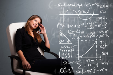 Beautiful school girl thinking about complex mathematical signs