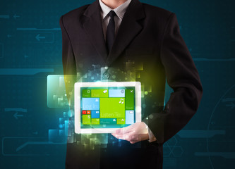Businessman holding a tablet with modern software operational sy