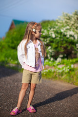 Cute little girl walking outdoor, having fun and laughing