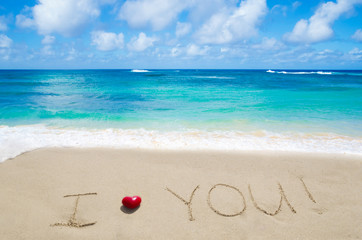 Sign "I love you" on the sandy beach