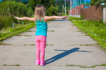 Little girl walking outdoor and having fun