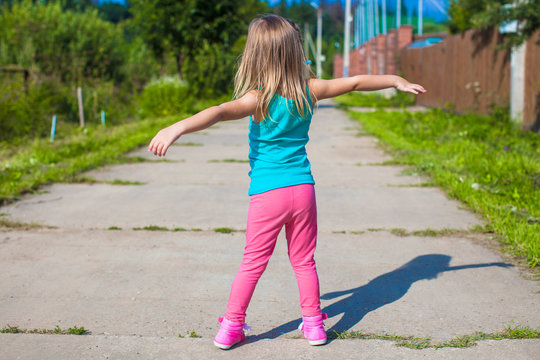 Little girl walking outdoor and having fun