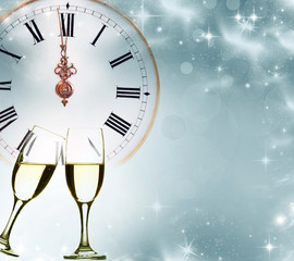 Fototapeta na wymiar Glasses with champagne and clock close to midnight