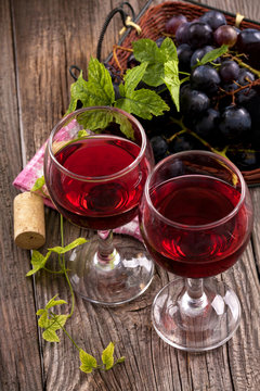 Red wine in glasses with grapes
