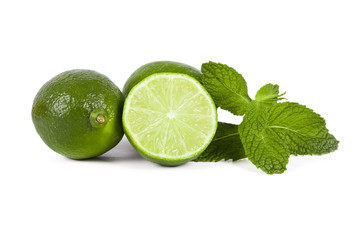 limes with mint leaves on white background