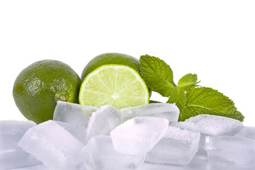 limes with mint leaves on white background