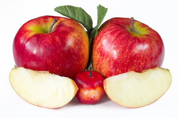 Naklejka na ściany i meble red ripe apples with green leaf and cut from the inside on a white background