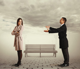young man apologizing to woman