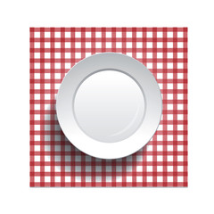 white plate on a checkered tablecloth