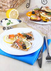 Salmon sandwiches on plate  on wooden table close-up