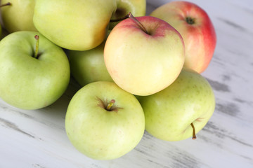 Juicy apples on wooden table