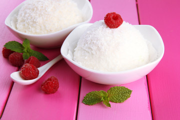 Delicious coconut cakes in bowls on table close-up