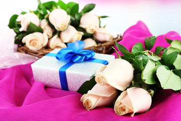 Beautiful bouquet of roses, on fabric, on light background