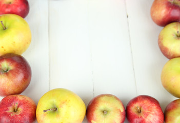 Juicy apples on white wooden table