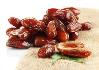 Dried dates on sackcloth isolated on white