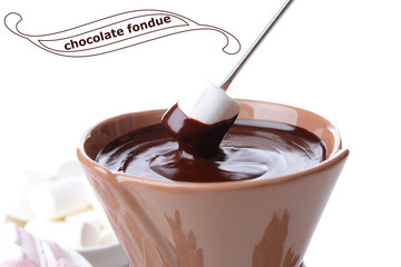 Chocolate fondue with marshmallow candies, isolated on white