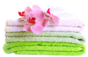 Obraz na płótnie Canvas Orchid flower and towels, isolated on white