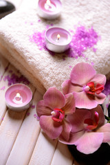 Fototapeta na wymiar Still life with beautiful blooming orchid flower, towel and spa