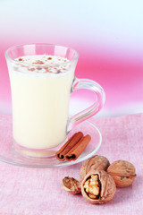 Cup of eggnog with cinnamon and nuts