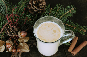 Obraz na płótnie Canvas Cup of eggnog with fir branches and Christmas decorations