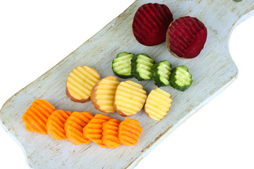 Beautiful sliced vegetables, on cutting board, isolated on