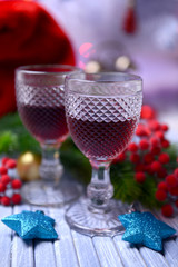 Wine glasses and Christmas decoration on bright background