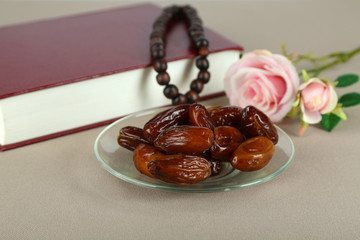 Composition with holy book,rosary and dates palm,