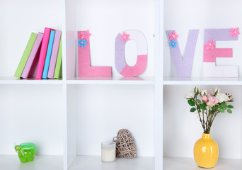 White shelves decorated with handmade knit word