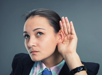 Young caucasian businesswoman try to hear something
