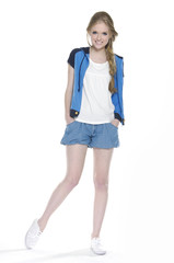 full-length young woman in Shorts posing on white background