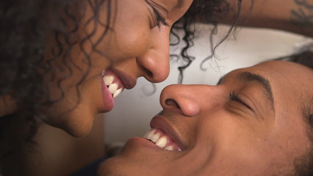 Cute black teen couple kissing and talking