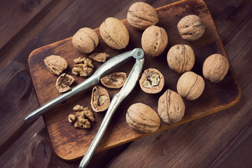 Still life with walnuts on a vintage wooden cutting board