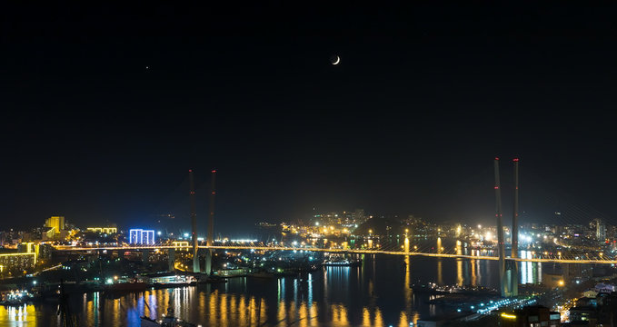 Vladivostok cityscape, with Venus and the Moon on sky.