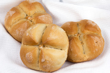 three buns for hot dogs on a towel