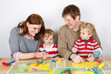 Fototapeta premium Happy family of a four having fun at home