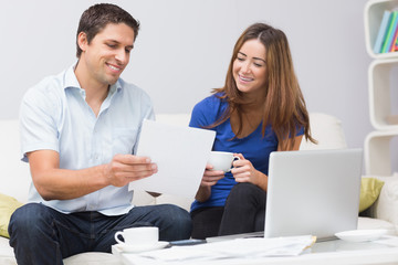 Couple paying their bills online at home