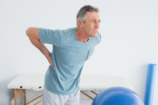 Man with lower back pain at the gym hospital