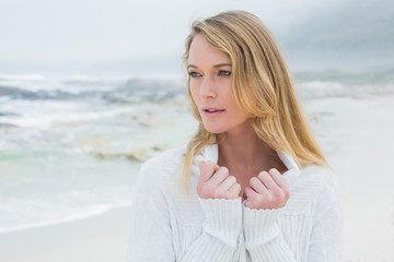 Contemplative casual young woman at beach