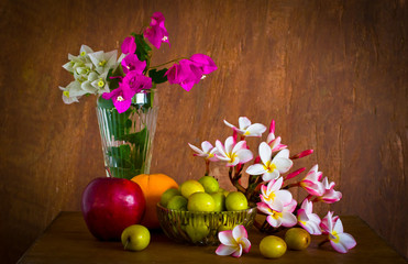 Fresh beautiful  flower and many fruit on old wood table ,still