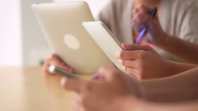 Close-up of Chinese businesswoman working on tablet