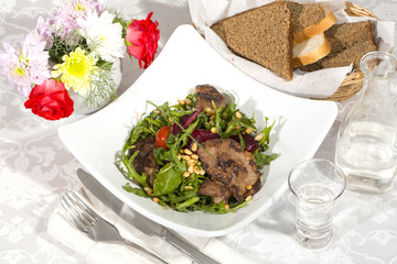 rabbit liver salad with arugula in a restaurant