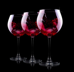 glass of red splashing wine