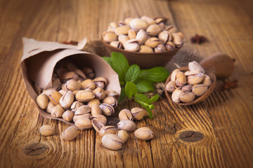 Pistachio nuts, close up on wooden table 