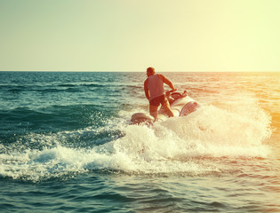 Silhouette of man on jetski at sea