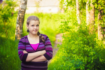 A Beautiful Young Girl Standing On A Forest Path Road